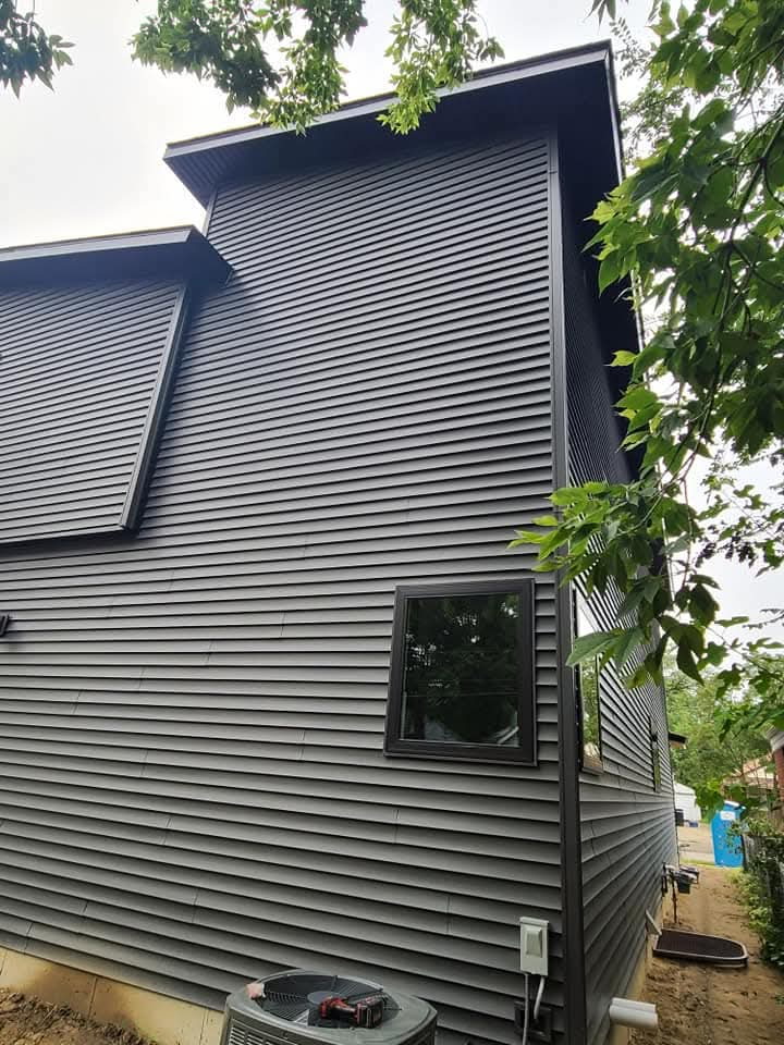 Side exterior showing dark horizontal siding and matching trim
